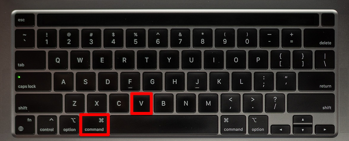 Pressing the Command+V keys on a keyboard
