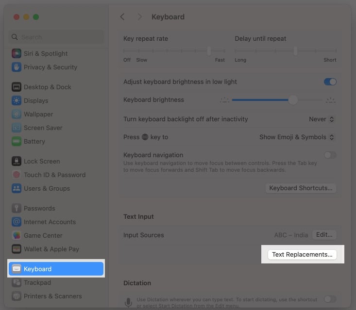 Accessing the Text Replacement option in macOS System Settings